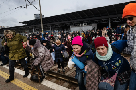 Kyiv residents scramble to catch trains heading west as Russian forces approach.