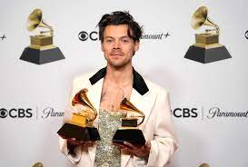 Harry Styles posing with his two Grammys